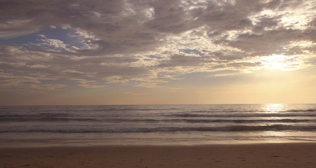 Beautiful sunset on Karon beach. The surf pounds the shore. Phuket, Thailand