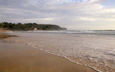 Beautiful sunset on Karon beach. The surf pounds the shore. Phuket, Thailand