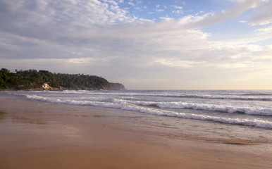 Beautiful sunset on Karon beach. The surf pounds the shore. Phuket, Thailand