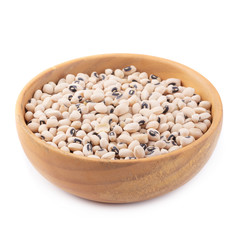 Black-eyed peas in a wooden bowl isolated on a white background