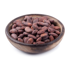 Cocoa fruit in a wooden bowl, raw cacao beans isolated on a white background