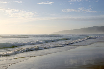 Beautiful sunset on Karon beach. The surf pounds the shore. Phuket, Thailand