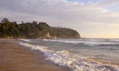 Beautiful sunset on Karon beach. The surf pounds the shore. Phuket, Thailand