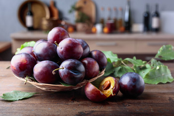 Ripe juicy plums on a kitchen table.