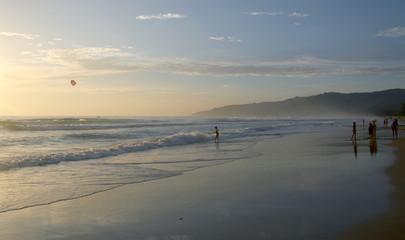 Beautiful sunset on Karon beach. The surf pounds the shore. Phuket, Thailand