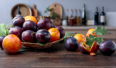 Ripe juicy plums on a kitchen table.
