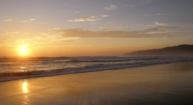 Beautiful sunset on Karon beach. The surf pounds the shore. Phuket, Thailand
