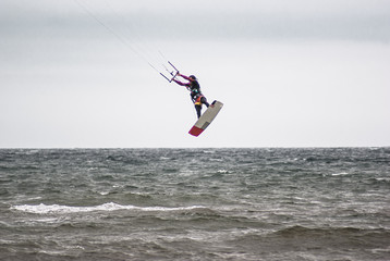 Kitesurfing. Athlete jumping out of the water