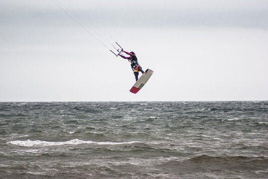 Kitesurfing. Athlete jumping out of the water