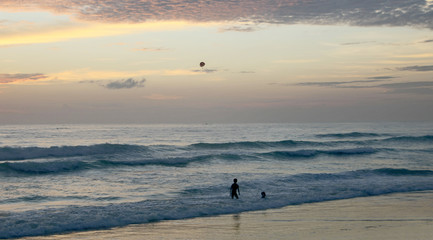 Beautiful sunset on Karon beach. The surf pounds the shore. Phuket, Thailand