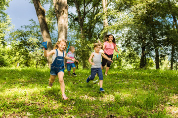 Naklejka na ściany i meble Happy kids running in the forest.