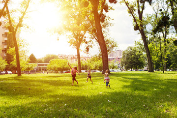 Carefree children flying a kite in the park.