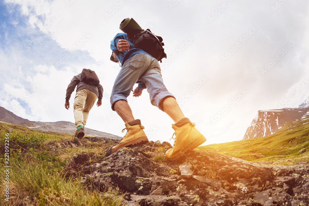 Wall mural trekking concept two tourists walking mountains