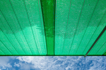 Green shading net roof against with blue sky background