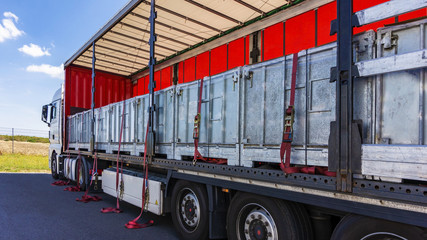 There is a loading to the truck trailer . Truck Trailer  . Cargo Transportation . Lorry horizontal .  Concept of wholesale  . fastening of freight in the trailer . distribution warehouse