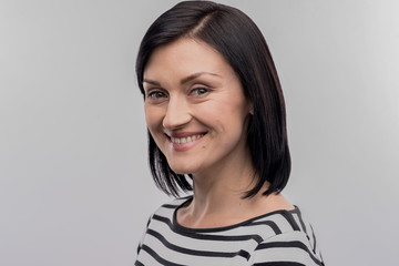 Appealing woman. Image without face retouching with green-eyed appealing woman wearing striped...