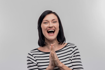 Thankful woman. Happy beautiful beaming woman feeling very thankful for good help on image without...