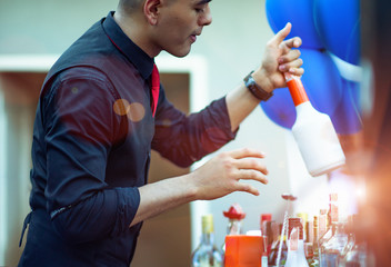 man bartender takes preparation in brew of cocktail mxing for party funny and entertainment, enjoyment at outdoor party