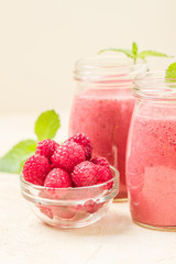 Raspberry smoothie close up photography with fresh summer blended cocktail and ripe berries.