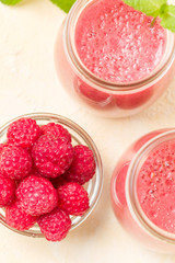 Raspberry smoothie close up photography with fresh summer blended cocktail and ripe berries.
