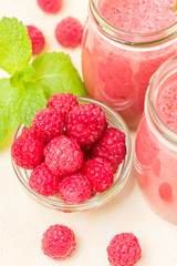 Raspberry smoothie close up photography with fresh summer blended cocktail and ripe berries.