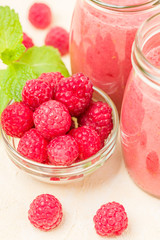 Raspberry smoothie close up photography with fresh summer blended cocktail and ripe berries.