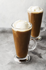 Ice coffee with ice cream on gray background