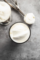 Ice coffee with ice cream on gray background. Top view. Food background