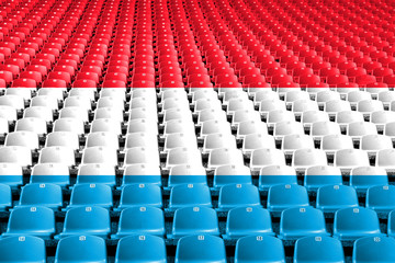 Obraz premium Siedziska stadionowe z flagą Luksemburga. Koncepcja konkurencji sportowych.