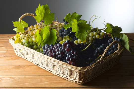 baket with grapes on the wooden table
