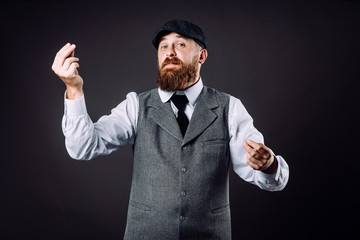 A bearded man in suit talking and gesticulating like italian on black background