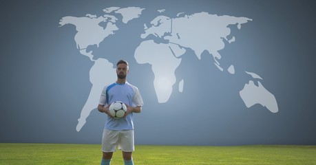 Soccer player holding football with world map