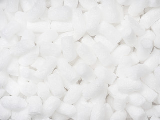 Filler packing background. Packaging foam pellets texture, top view, close-up. Polystyrene, white...