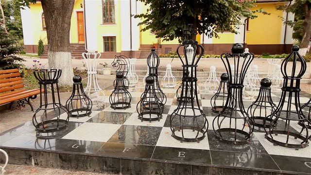 Outdoor big chess board with melal pieces, outdoor chess in the park, Large chess game on ground in the park