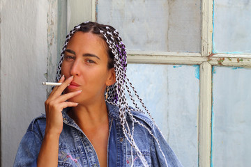 brunette woman with pigtails Smoking a cigarette