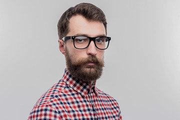 Smart man. Smart bearded dark-haired man wearing glasses standing near white wall on image without...