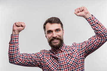 Happy worker. Image without face retouching with dark-haired bearded office worker feeling happy...