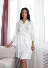 Beautiful sexy woman wear silk pajama style casual girl with dark hair fashion catalog lady perfect face cosmetic and body makeup meeting walk interior room.