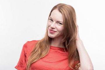 Fototapeta premium Appealing woman. Beaming appealing woman wearing bright red shirt feeling excited on image without face retouching