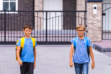 Schoolboys with backpack go to school