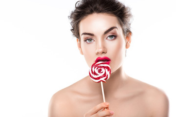 attractive nude girl eating red lollipop, isolated on white