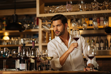 Which is the best. Smart handsome man trying different types of wine while deciding which one is the best