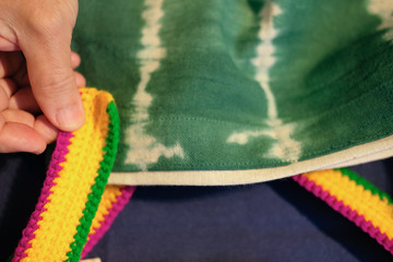 hand making tie dye fabric handbag