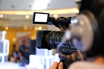 Fototapeta na wymiar video production camera recording live event on stage. television social media broadcasting seminar conference.