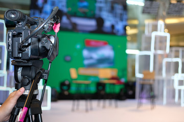 video production camera recording live event on stage. television social media broadcasting seminar conference.