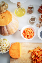 Ingredients and spices for pumpkin soup preparing on the table