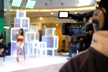 video production camera recording live event on stage. television social media broadcasting seminar...