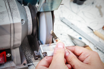 Close-up of sharpening the metal cutter on the grinding machine