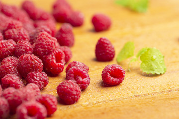 Fresh raspberry with mint on wooden background