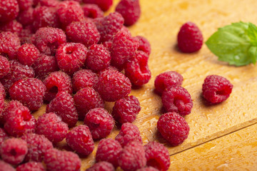 Fresh raspberry with mint on wooden background